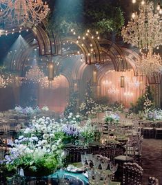 an elaborately decorated banquet hall with chandeliers and tables set for formal function