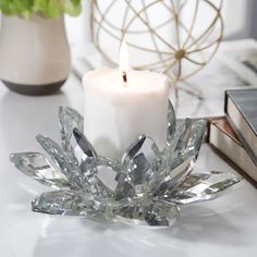 a white candle sitting on top of a table