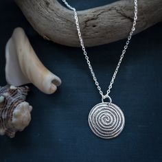 This silver domed spiral necklace remind us of the importance of turning in and listening to the wisdom that is inside of us. Necklace is sterling silver and measures approximately .75" in diameter. It hangs on an 18 inch sterling silver rolo chain. If you would like a longer or shorter chain, or a snake chain, please let me know in the comments section while checking out. The raised areas are polished silver while the recessed areas have a dark patina that accentuates the texture and makes them Silver Swirl Necklace For Gifting, Silver Swirl Necklace For Gift, Silver Swirl Necklace Perfect For Gifts, Nickel-free Sterling Silver Swirl Necklace, Sterling Silver Swirl Necklaces, Handmade Spiral Silver Necklace, Minimalist Silver Spiral Necklace, Silver Spiral Necklace For Gifts, Handmade Silver Spiral Necklace