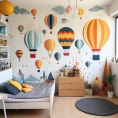 a child's bedroom with hot air balloons painted on the wall