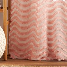 a pink and white curtain with waves on it