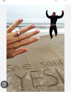 someone is jumping in the air with their hand out to show off her engagement ring