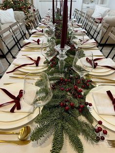 the table is set for christmas dinner with red and green decorations