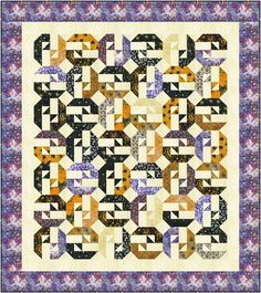 a quilt with an abstract design on it's center and two rows of different shapes