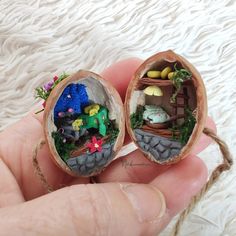 two miniature figurines in the palm of someone's hand