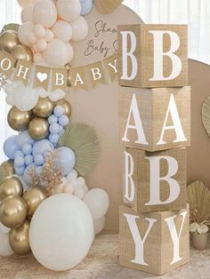 a baby shower decoration with balloons and other items