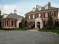 a large red brick house with black shutters