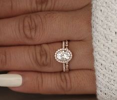 a woman's hand with two rings on it and a diamond ring in the middle