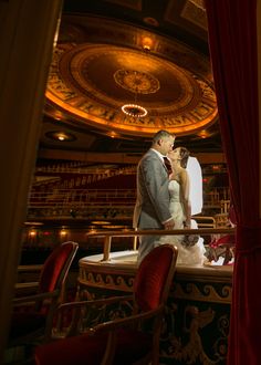 a bride and groom are standing in front of the stage at their wedding reception,