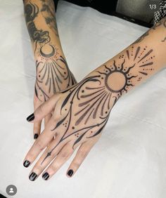 a woman's arm with tattoos on it and her hand in the shape of a sun