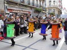 some people are walking down the street in costumes