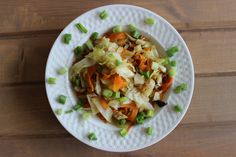 a white plate topped with cabbage and carrots