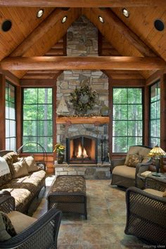 a living room filled with lots of furniture and a fire place in the middle of it