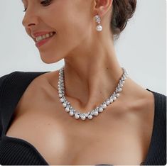 Pearl and CZ Wedding Jewelry Set Complete your elegant wedding day look with our fabulous pearl and CZ necklace and earring set. This glamorous platinum silver plated jewelry set features dazzling AAAAA quality CZ crystals in round and teardrop cuts as well as lustrous pearl beads. This luxurious jewelry set will add timeless elegance to any bridal ensemble. Size: The necklace is about 17" long and the pierced earrings are about 1" long. Color: Silver. Style: ne10130. Please allow about 3 weeks for delivery. Shipping Policy . Return Policy Elegant Pearl Bridal Sets With Pearl Drop, Silver Pearl Bridal Sets For Formal Occasions, Elegant Pearl Bridal Sets For Formal Occasion, Formal Silver Pearl Bridal Sets, Elegant Silver Pearl Jewelry Sets, Silver Cubic Zirconia Pearl Necklace For Wedding, White Gold Pearl Necklace With Cubic Zirconia For Wedding, Silver Bridal Necklace With Pearl Drop And Cubic Zirconia, Elegant Crystal Jewelry Sets With Pearl Drop