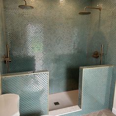 a bathroom with two sinks and mirrors on the wall next to each other in front of a shower