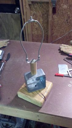 a wooden table topped with lots of tools