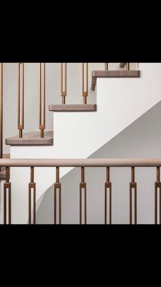 a stair case with wooden handrails and white walls