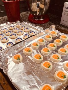 there are many small cookies on the pans ready to be baked in the oven