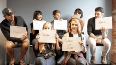 a group of people holding up signs in front of their faces with writing on them