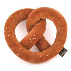 two rings made out of brown fabric with white dots on them, one is shaped like a pretzel