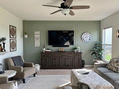 a living room filled with furniture and a flat screen tv mounted on the wall above a fireplace