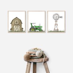 three farm animals are hanging on the wall next to a wooden stool and two pictures