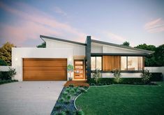 a modern house with an open front door and large grass area next to the driveway