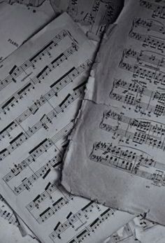 old sheet music sheets are piled on top of each other