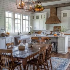 a kitchen filled with lots of wooden furniture and white cabinets next to a stove top oven