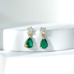 Product Details If youre looking for a stunning accessory for your special occasions and events, consider the sparkling and elegant Drop Earrings. These earrings feature a Round Cut Moissanite at the top, with a stunning Pear Cut Created Emerald dangling below, all set in gold. The earrings are designed with screw-backs for a comfortable and secure fit. These Gemstone Earrings would make an excellent anniversary gift for your partner, surprising her with their beauty and elegance. Product Inform Gemstone Dangle Earrings, Lab Created Emerald, Emerald Earrings, Green Gemstones, Pear Cut, Teardrop Earrings, Gemstone Earrings, Prong Setting, Anniversary Gift