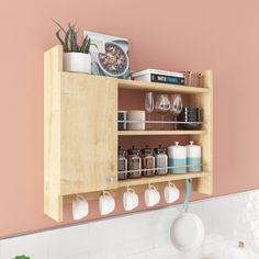 a kitchen with pink walls and white counter tops, an open cabinet above the sink