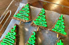 green frosted christmas trees on toasted bread sticks with sprinkles in the middle