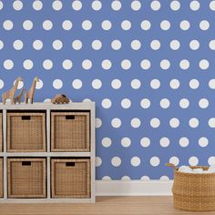 a blue and white polka dot wallpaper in a child's room with toy animals