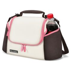 a white and black lunch bag with pink trimmings on the side, holding a bottle of soda