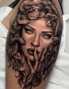 a woman's face with snakes on her head and hands in the shape of a snake