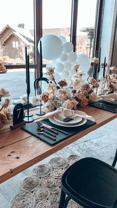 a long table with plates and flowers on it