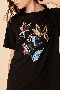 This adorable floral print tee features a black t-shirt with a bright floral graphic. Perfect to pair with a skirt or a pair of your favorite jeans. 60% cotton, 35% polyester, 5% spandex Floral print Round neck Standard fit Made in China Size ChartNote that this is the brand's general size chart. Each style may vary slightly in measurements. Small Medium Large Bust 35" 36" 38" Shoulder 14.25" 14.75" 15" Merch Photography, Floral Graphic, Black Floral Print, Print Tee, Embroidery And Stitching, Large Bust, Black T Shirt, Printed Tees, Favorite Jeans