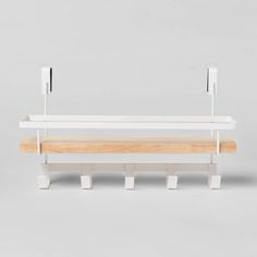 a white bench with two wooden benches on each side and metal brackets attached to the back