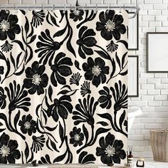 a black and white shower curtain with flowers on it