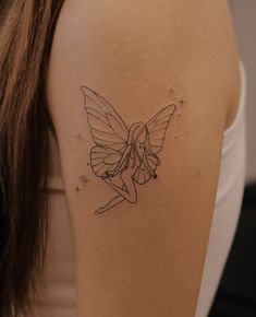 a woman with a tattoo on her arm has a fairy tinkerbell in the shape of a butterfly