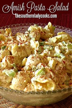 a bowl filled with pasta salad on top of a table