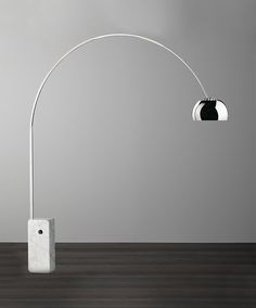 a white floor lamp sitting on top of a wooden table