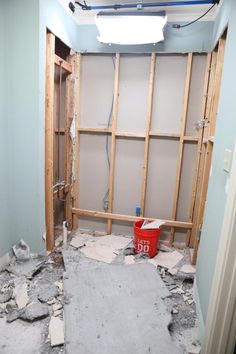 an unfinished bathroom is shown with the walls torn off and debris on the floor in front of it