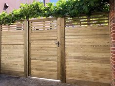 a wooden fence with plants growing over it