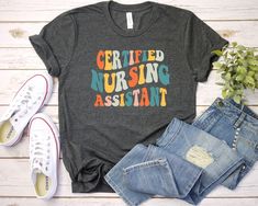 Certified Nursing Assistant Shirt - Unisex T Shirt, Women Racerback Tank, Long Sleeve T-Shirt Tees Tshirt Sweatshirt Sweater Hoodie Gift For Men Women Boys Girls CNA gift,cna life,cna shirt,nursing assistant,cna shirts,cna,cna sweatshirt,cna tshirt,cna appreciation,cna graduation gift Well, let's say goodbye to all this boring apparel... The GodBlessThisDesign team creates custom clothes with great designs to suit all tastes. Our unique and blessed designs are a blast fit for every occasion and Physical Therapy Shirts, Occupational Therapy Shirts, Papa T Shirt, Therapist Gifts, T Shirt Women, Look Plus, Unisex Shirts, Gift For Men, Teacher Shirts