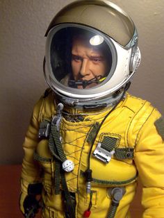 a man in a yellow space suit with a helmet and goggles on his face