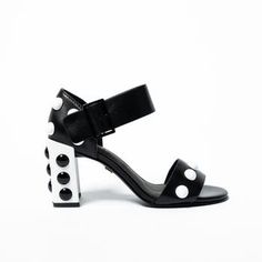 Supersized  studs inspired by Roman palace architecture shine boldly on this block heel of this ankle-strap leather sandal. 8 1/4" Heel Ankle Strap Closure Fits True to Size Leather Upper and Lining Studded Heels For Summer Evenings, Studded Leather Heels For Summer, Summer Leather Heels With Studs, Leather Heels With Studs For Summer, Spring High Heel Sandals With Studs, Studded Leather Heels, Chic Studded Open Heel Sandals, Spring Studs Block Heel Heels, Studded Evening Sandals For Spring