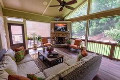 a living room with couches, chairs and a television