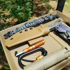 several different types of knifes and other items on a table in a box outside