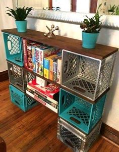 a bookshelf made out of metal containers with plants on top